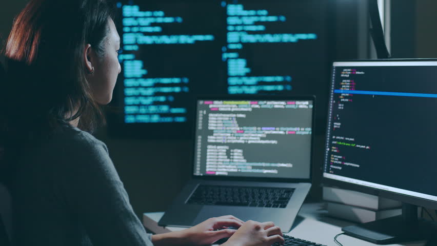 Young Asian woman, developer programmer, software engineer, IT support, working hard at night overtime on computer to check coding in bugging system Royalty-Free Stock Footage #1099078899