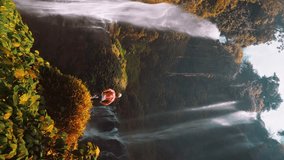 Active lifestyle people travel in tropical rainforest jungle and enjoy beautiful waterfall hidden in tropical rainforest jungle on nature background 4K