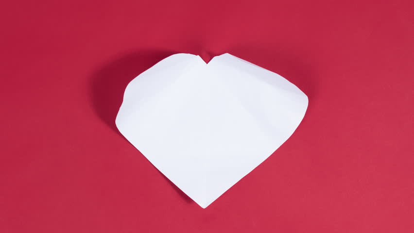 4k Big white heart appears on red background. Symbol of love. Greeting card. Concept of valentine's holiday, wedding and other occasions to express love. Stop motion animation. Flat lay. | Shutterstock HD Video #1099079951