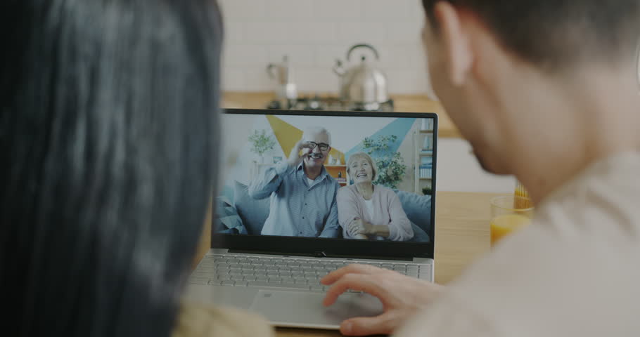 Portrait of happy young couple talking to parents senior people during video call using laptop at home. Family life and communication concept. | Shutterstock HD Video #1099081735