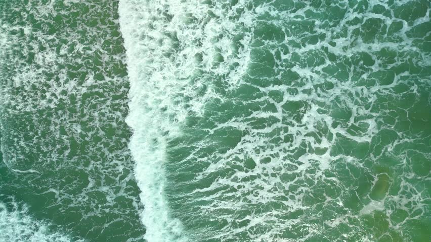 Drone filming breaking surf with foam in Vietnam ocean. Big swell in Asia.Beautiful texture of big power dark ocean waves with white wash. Aerial top view footage of fabulous sea tide on a stormy day. | Shutterstock HD Video #1099081895