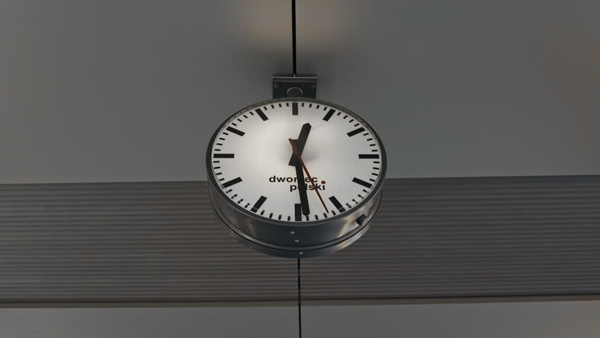 Public clock in railway station at the hanging with roof of subway central train station. It is clock for watch time waiting public travel and transportation metro train. High quality FullHD footage