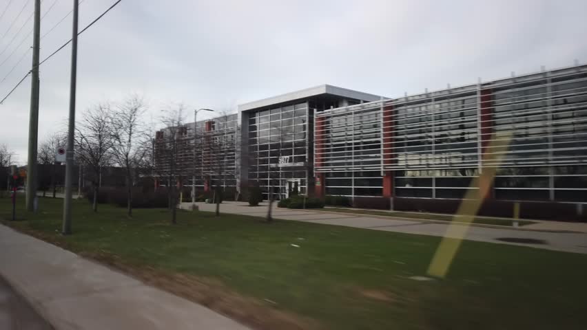 QUEBEC, CANADA - NOVEMBER 2022: Unbranded modern office building with glass walls on the side of the Trans-Canada Highway service road.
