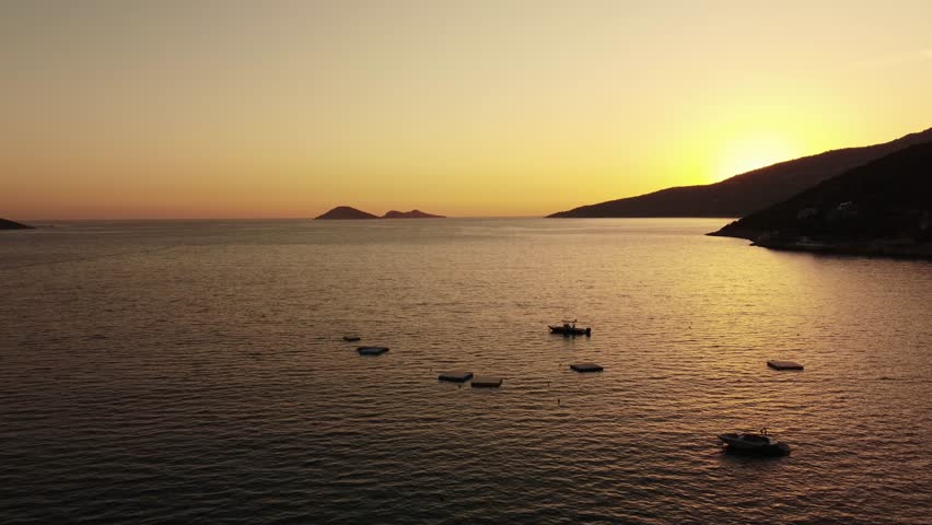 Aerial view of Bali beach island and sliver of sand on Sunset beach in the evening, sunset sea view with mountains, drone aerial.