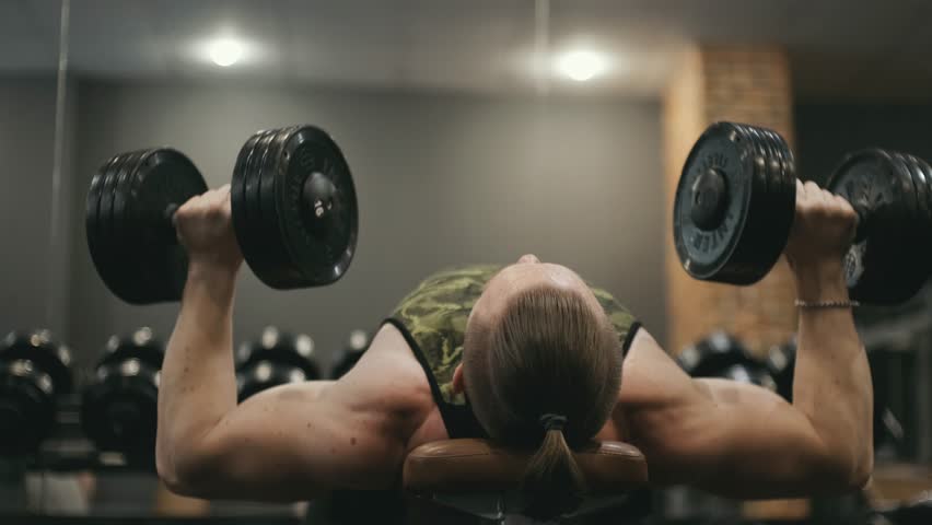 Muscular bodybuilder man lifting heavy weights black dumbbells. Gym concept. Healthy lifestyle. Royalty-Free Stock Footage #1099091891