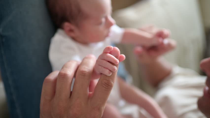 Baby grasping finger of father | Shutterstock HD Video #1099095905