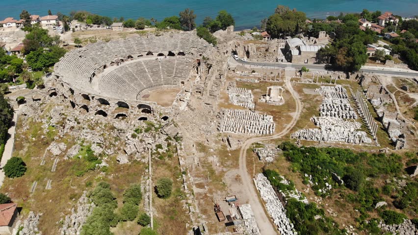 Scenic aerial view of partially restored antique Roman theater in ancient city of Side on Mediterranean coast in Antalya province on sunny spring day, Turkey