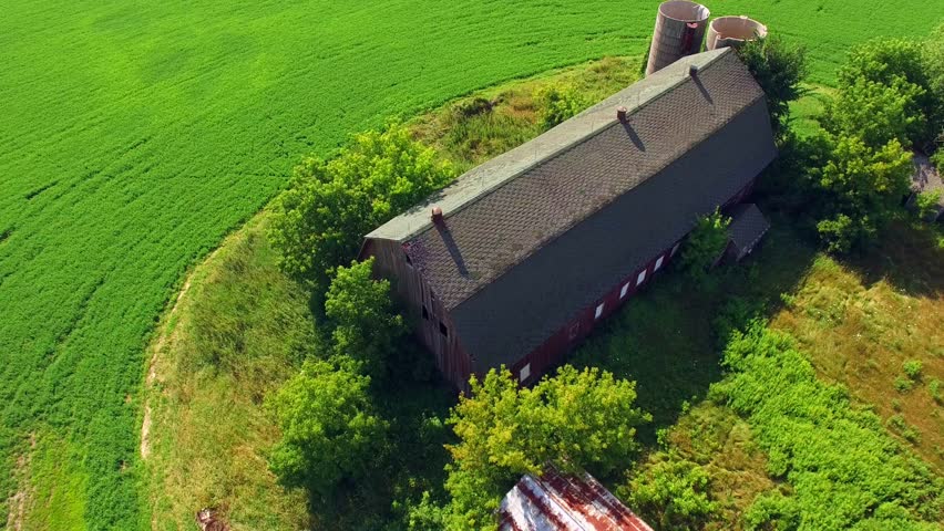 Scenic View of Abandoned Rustic Barn and Silos
