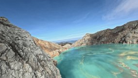 Volcano crater island mountain crack stone sharp structure with acid lake turquoise blue water miss fog aerial view. FPV freestyle sport drone shot geology formation pond cliff rocky terrain nature 4k