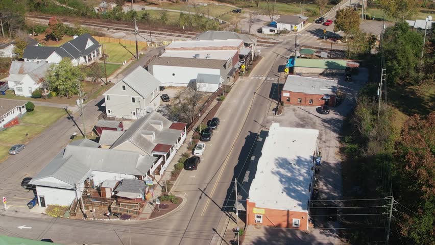 Aerial pass over shops and railroad tracks in Old Town Helena, Alabama