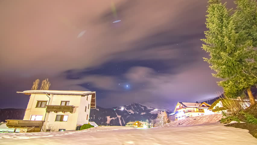 Milky Way Galaxy spin above snow covered rural town, fusion time lapse