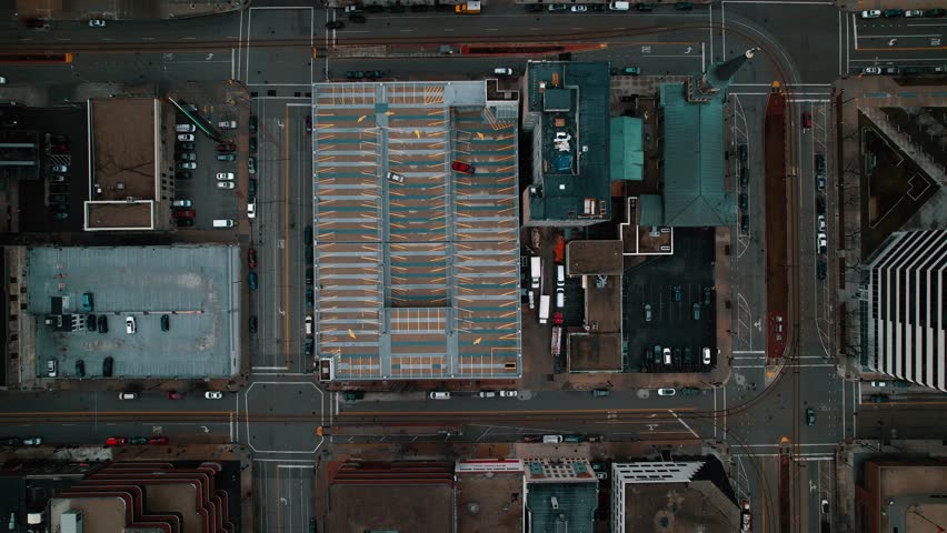 cinematic top down of milwaukee, wisconsin, USA. Cinematic gotham city vibes. Flying above buildings, structures, roads. Dark and dramatic feel.