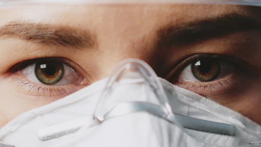 Close up female asian doctor eyes in protective glasses and facial mask looking serious. Woman nurse portrait in uniform. Concept of health care and medicine. Hospital equipment. Coronavirus COVID-19 Royalty-Free Stock Footage #1099102703