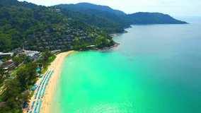 Drone are flying over tourists sunbathing and relaxing on the Kata Noi Beach in Phuket, Famous tourist attractions in Southeast Asia, Thailand. sea background. Amazing high quality stock video
