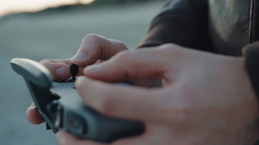 Hand of a man pilot the sport fpv drone with remote controller