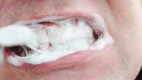 a man's mouth close-up. a man brush your teeth with toothbrush and toothpaste. concept of hygiene and health of teeth and oral cavity. daily care and brushing of teeth. - Powered by Shutterstock - Get 15% off with code: PIKWIZARD15