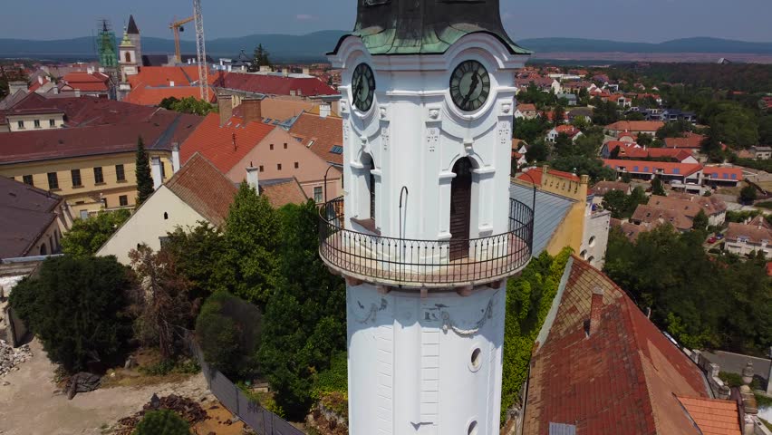 Veszprem, Hungary - 4K flying away from Fire-watch tower at the medieval district of Veszprem Ovaros square on a bright summer day with clear blue sky