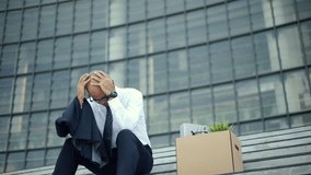 Unemployed male employees sit stressed and sad from the economic crisis. Depressed and tired  businessman job loss from bankrupt business. Failure man dismissal employee. Unemployment growth concept. - Powered by Shutterstock - Get 15% off with code: PIKWIZARD15