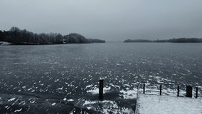 Ice lake in Germany. Winter. Landscape. Drone view of ice covered lake. Snowy forest in cold winter. 