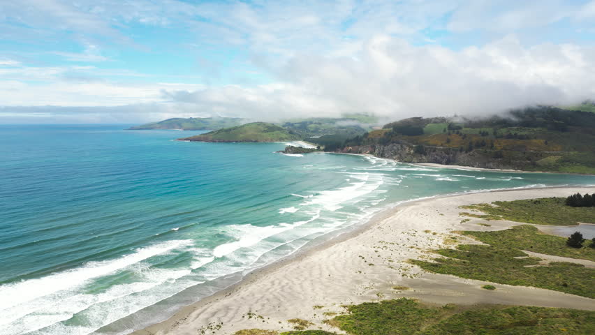 Paradise beach and majestic mountains on Pacific coast South Island, New Zealand, aerial panorama
