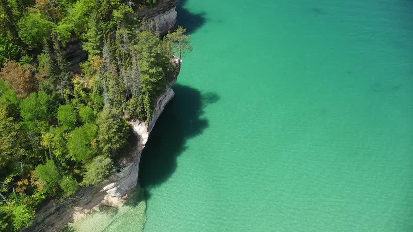 Aerial Pan Up of Lakeshore Rock Cliffs - Pictured Rocks National Lakeshore, Michigan Royalty-Free Stock Footage #1099112905