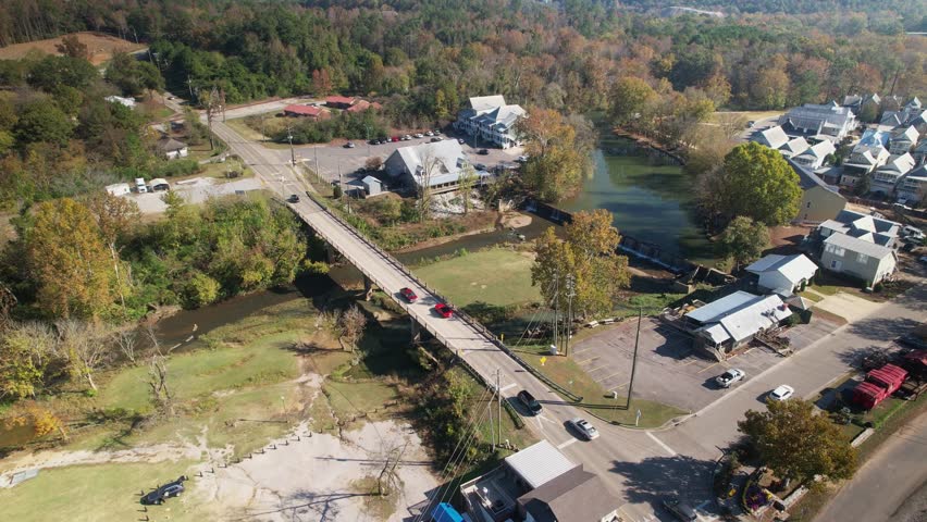 Aerial over bridge crossing over creek and waterfalls in Old Town Helena, Alabama