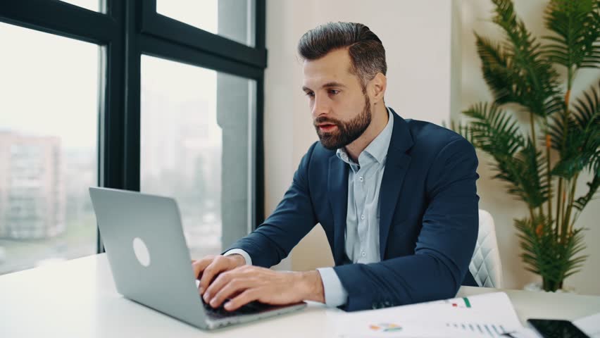 Stressed worried upset tired caucasian businessman, corporate director, financial manager, sits in the office at workplace, nervous of deadline a project, closed his eyes, holding hand on head | Shutterstock HD Video #1099113549