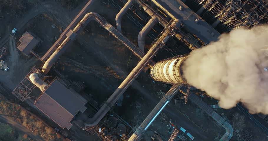 Pollution of the environment with industrial smoke from a large pipe taken from a great height. Climate change on the planet and global warming. The factory pollutes the environment Royalty-Free Stock Footage #1099116299