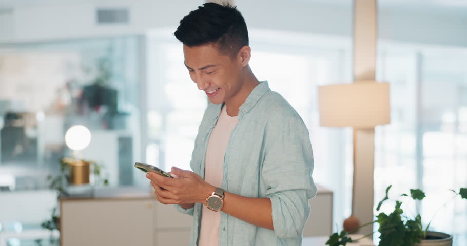 Phone, office and Asian man browsing on social media or mobile app and laughing at a meme. Technology, happy and male employee scrolling on the internet with a cellphone on a break in the workplace. Royalty-Free Stock Footage #1099117877