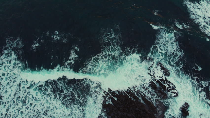 An aerial view of beautiful ocean waves with foam | Shutterstock HD Video #1099118531