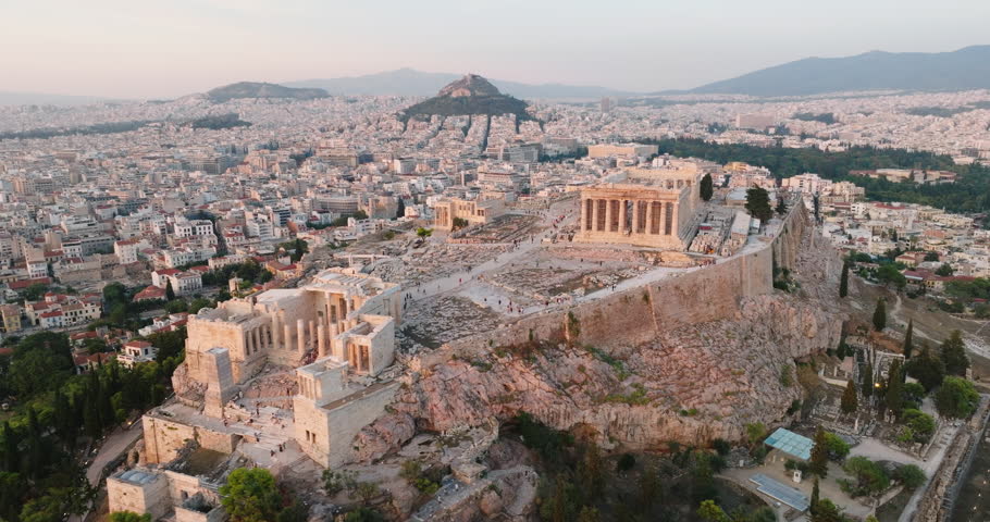 Greece Acropolis city of Athens parthenon symbol of ancient aerial view slide from drone on panorama of residential buildings at sunset summer. Lights sun, lens flare. World Heritage sites. History Royalty-Free Stock Footage #1099119835