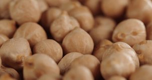 Raw chickpeas, rotation. Chickpeas, close-up dolly shot. Macro footage of chickpeas beans. Food cooking video.