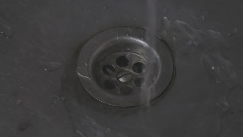 Tap water flows into a tin sink | Shutterstock HD Video #1099122053