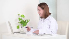 Asian doctor talking with patient via laptop computer, Medical online