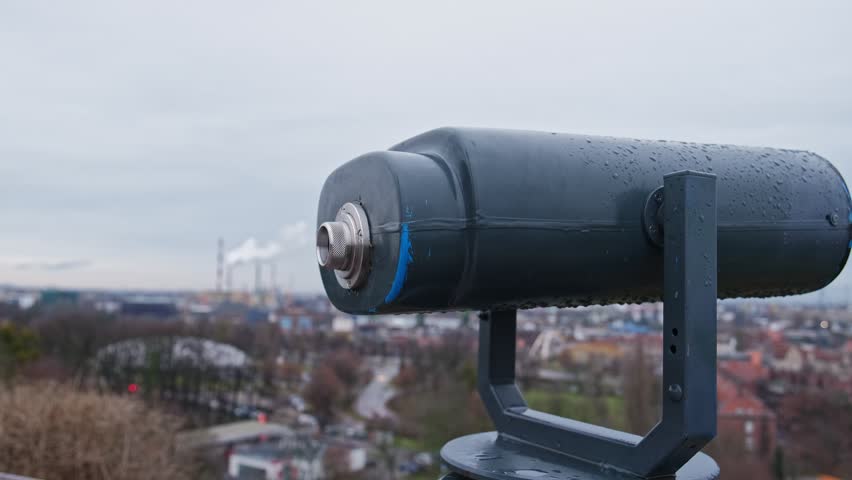 Caucasian Girl Looking At Distant Cityscape Through a Telescope Permanently Mounted on Sightseeing Point