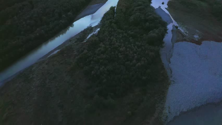 Flying above river flowing into Black sea against colourful sunset