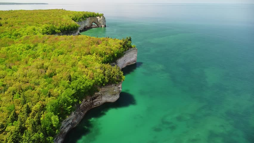 Aerial Pan Up Coast of Sandstone Rock Cliffs with Sea Arch, Pictured Rocks National Lakeshore, Munising, Michigan