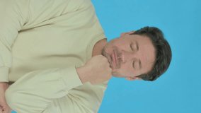Handsome Young Man Sleeping on Blue Background, Vertical Video