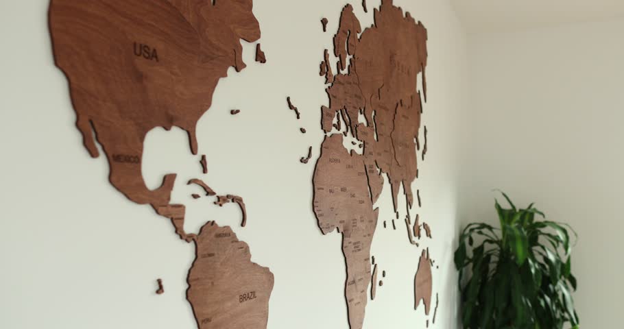 Wooden world map pan full view in modern room with white wall design. High quality 4k footage