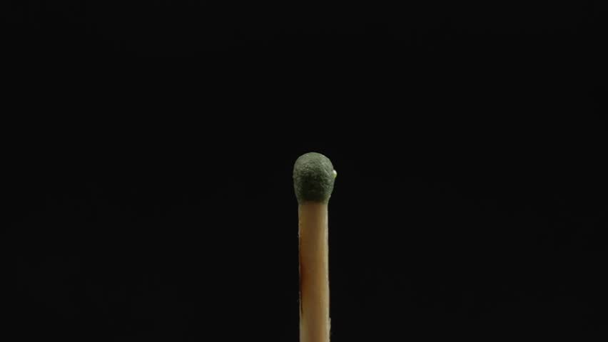 Closeup Match burning and combusting on black background. Match lights up in slow motion arbitrarily from burning air or temperature. No traces of arson. Spontaneous combustion of sulfur . | Shutterstock HD Video #1099139283