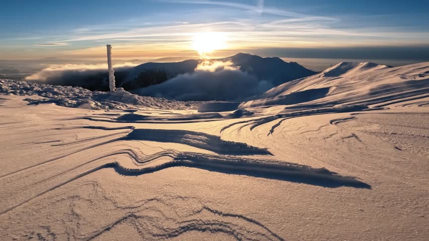 Sunrise over beautiful snow structure in frozen winter alps mountains nature background
