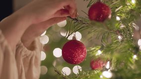 Hanging Christmas bulb on Christmas tree, lights shining, Christmas season, dream, holiday season. 4K 24FPS - Powered by Shutterstock - Get 15% off with code: PIKWIZARD15