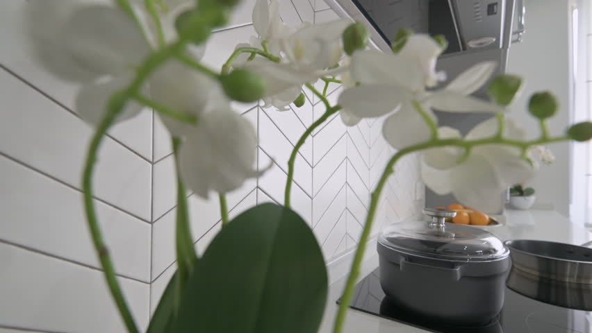 Closeup view to worktop at large luxury modern classic gray and white kitchen