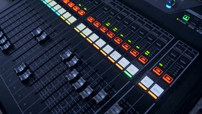 Professional instrumental sound engineer in a TV studio or at a concert. Video production. Record. Close-up music digital mixer for stage setup. Video recording. Video camera. UK London 01.2023