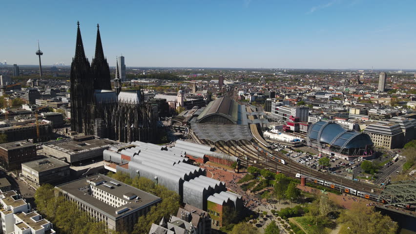 Aerial slide display Cologne Central Station amidst Cathedral Germany