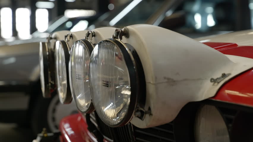 Close up of head lights of BMW e30 old vintage vehicle car, indoor, day Royalty-Free Stock Footage #1099152659