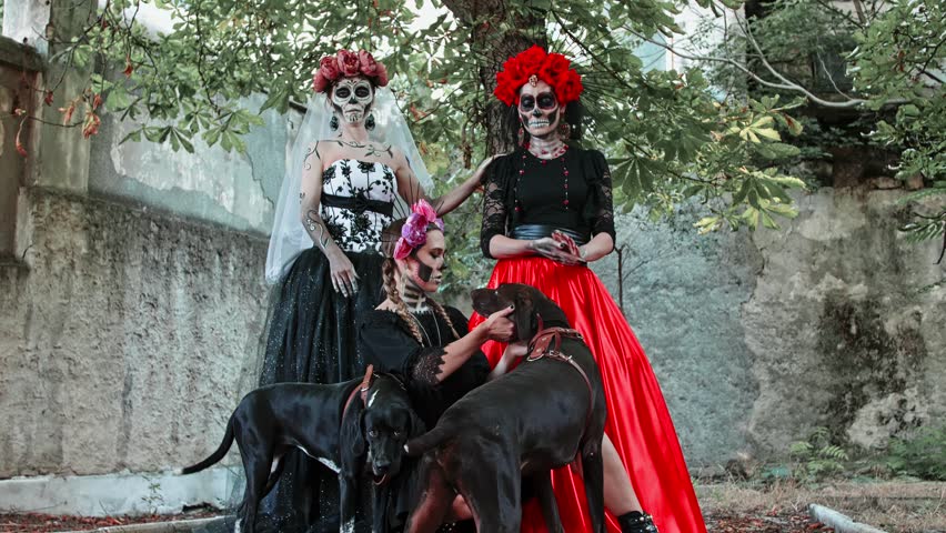 Slow motion Costume performance of three Women in the guise of Holy Death with dogs. Traditional Dia de Los Muertos Festival in Mexico Royalty-Free Stock Footage #1099156331