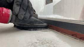 Construction works. Grinding a concrete floor or cement-sand screed to eliminate irregularities before finishing work. 4k video footage
