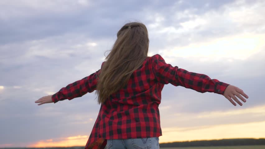 Cute child enjoys freedom with outstretched arms, dreams of flying. child aviator in park at sunset with outstretched arms. girl enjoys happiness, flight, dream. Child pilot, arms out to sides. | Shutterstock HD Video #1099157793