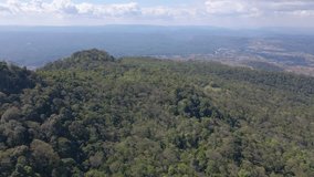 Aerial view footage of the drone flying over the mountain and rainforest with sunshine 